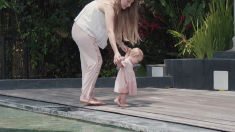 baby and mother walking on terrace