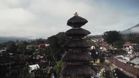 drone rotate around kintamani hindu temple in indonesia bali island with scenic foggy landscape mount batur