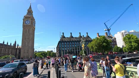 crowds gather near big ben on a sunny day