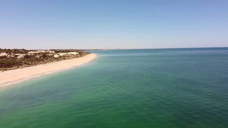 aerial flyover calm turquoise waters of mindarie beach, perth australia