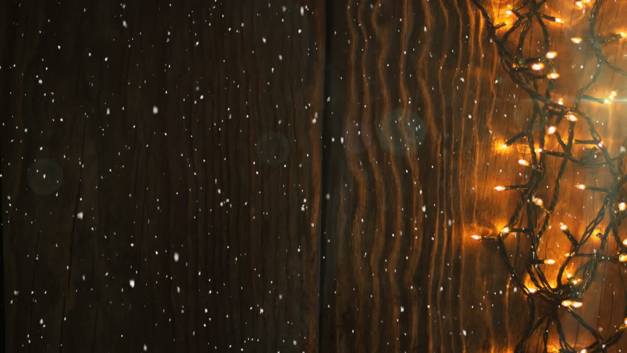 나무와 크리스마스 요정 빛 장식 위에 떨어지는 눈의 애니메이션