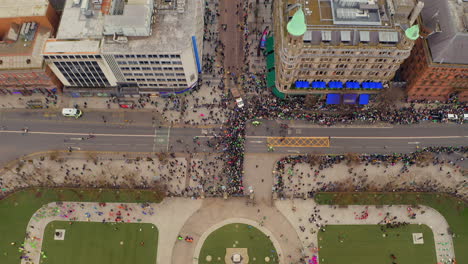 aerial tilt revealing belfast crowds awaiting st. patrick's parade.