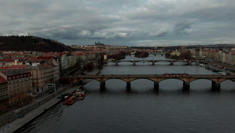 drone flight over vltava river in prague close tho bridge