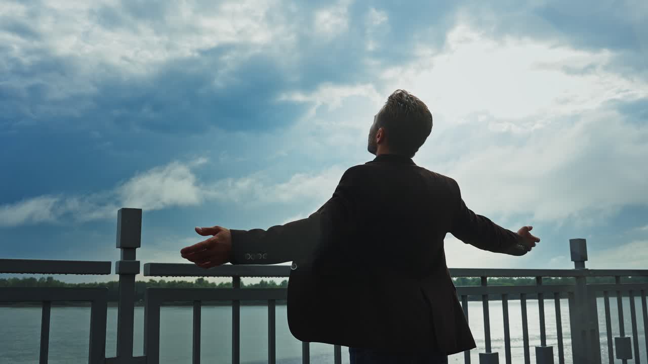 Man enjoying a view of the river on a cloudy day