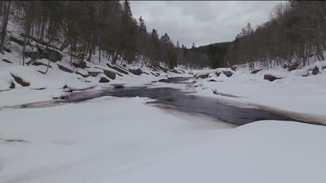 Antena-Escénica-Dron-Adelante-Desierto-Canadiense-Mediados-De-Invierno-Cerca-Del-Norte-De-Quebec-Estación-De-Esquí-De-Stoneham-De-Congelado-Sobre-El-Río-Sautaurski-Frío-Nublado