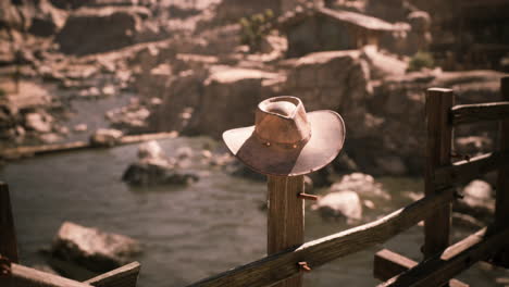 cowboy hat on a fence in the desert