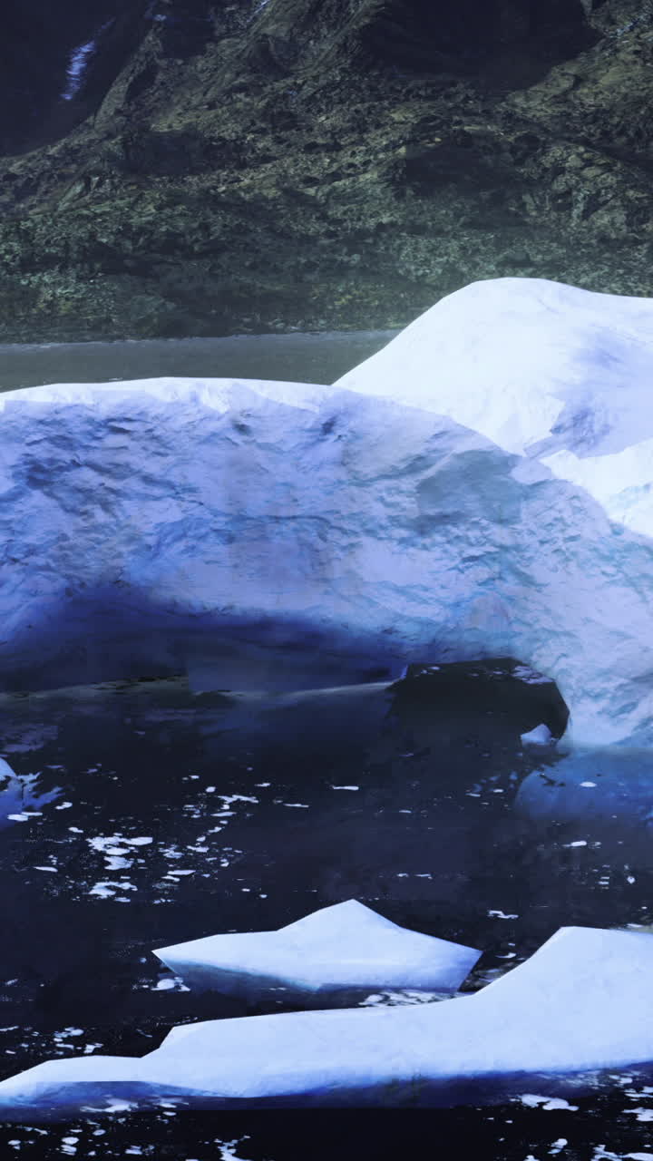 Majestic ice arch dominates a serene arctic landscape under soft sunlight