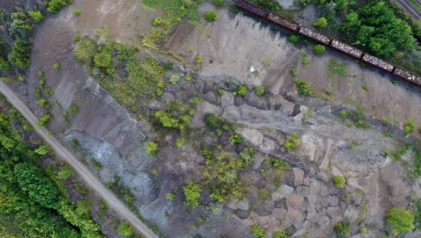 top-view-of-a-rail-track-with-train-in-summer-sunset