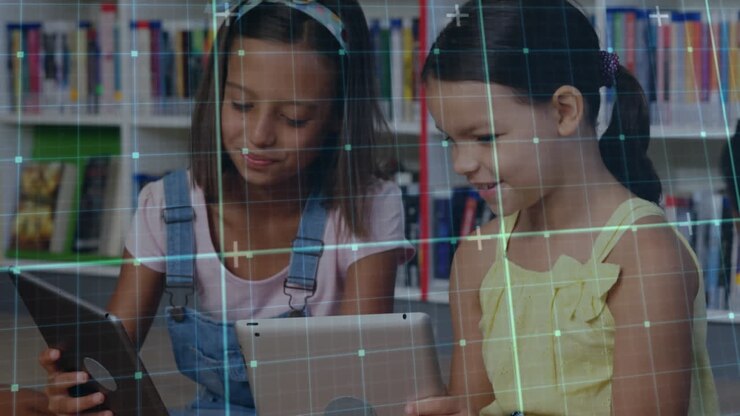 Animation of grid network against two diverse girls using digital tablets in the class at school