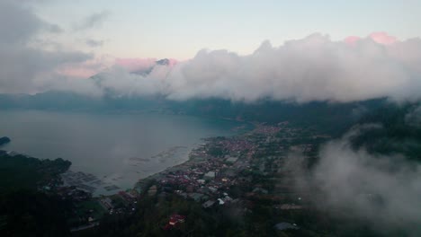 aerial reveal coastal town in danau batur lake, kintamani, bali, indonesia