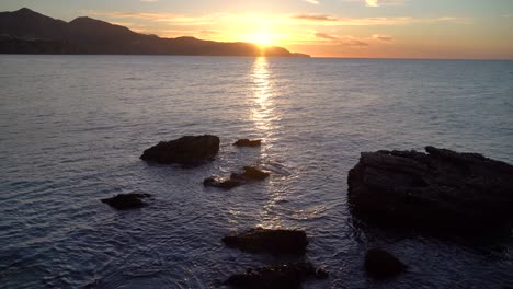 stunning view of ocean with rock silhouettes at early morning sunrise