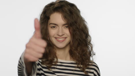 Happy-girl-showing-thumbs-up-on-white-background.-Young-woman-showing-like-sign