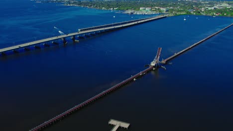 aerial during sunshine day over csx train bridge, bascule bridge open, bradenton florida