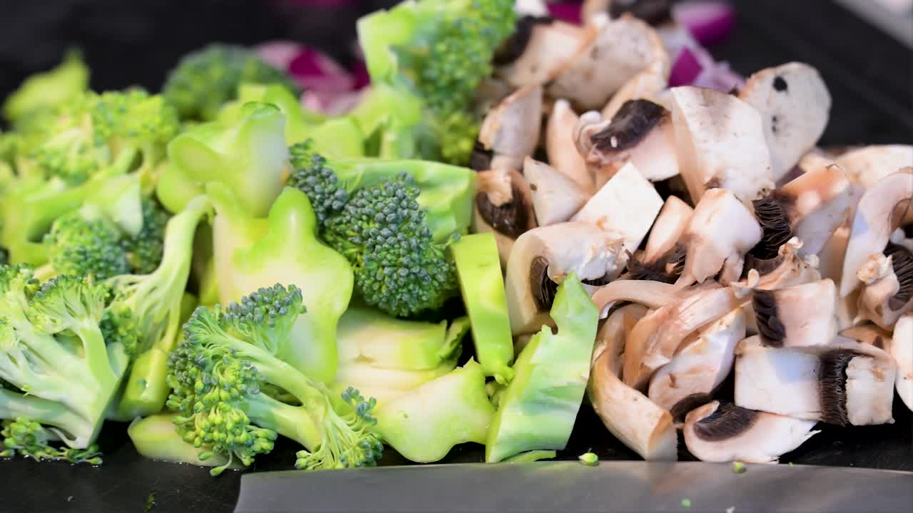 Vegetarian and vegan-friendly ingredients are prepped: broccoli, mushrooms, and onions. This clean eating shot is perfect for plant-based recipes and healthy cooking