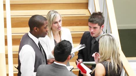 Business-team-speaking-about-work-in-stairs-footage