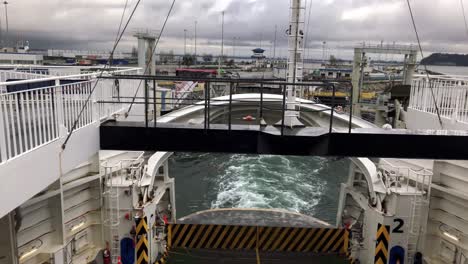 ferry using its enigine to depard from the ferry terminal on a cloudy day