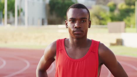 Disabled-mixed-race-man-with-prosthetic-legs-focusing-before-a-race