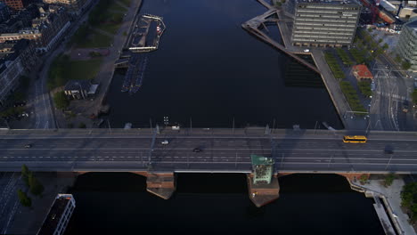 Drone-flying-backwards-showing-a-bridge-over-the-canal-in-Copenhagen-and-slowly-revealing-the-city-and-the-harbour