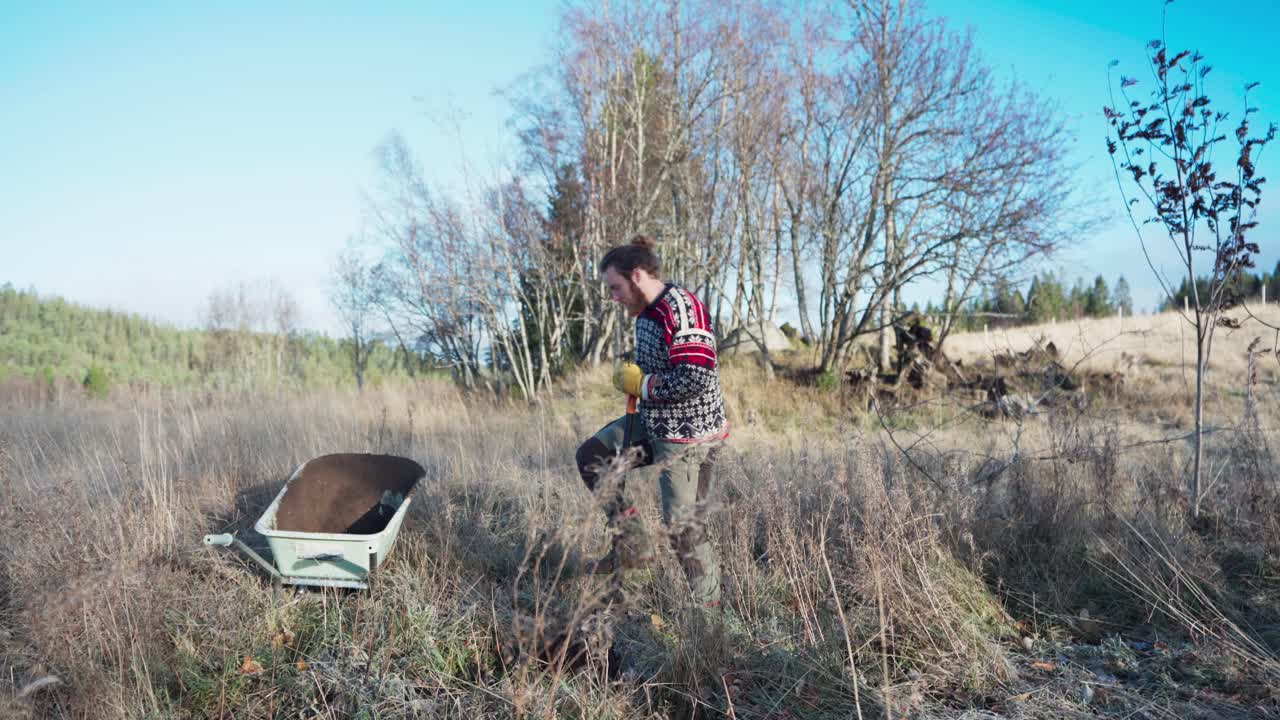 A Man With Shovel Digging And Removing Grass