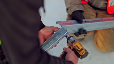installing of solar cell. solar panel technician with drill installing solar panels