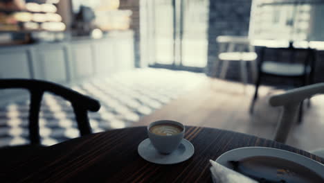 coffee cup on wooden table in modern cafe