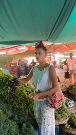 woman shopping for vegetables at a market