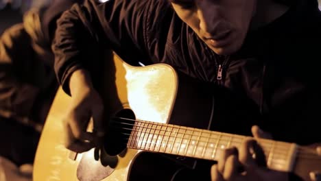 a passionate guitarist plays under night lights, capturing the essence of music and emotion in a serene outdoor setting, surrounded by a mysterious atmosphere.
