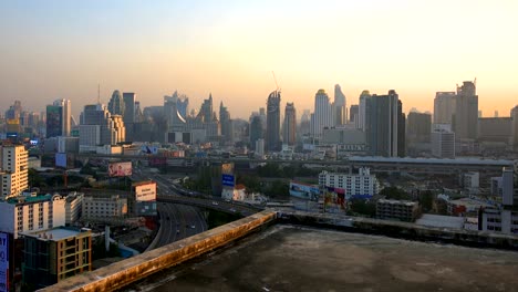 rooftop edge with buildings at sunset, skyscrapers in bangkok city, thailand.