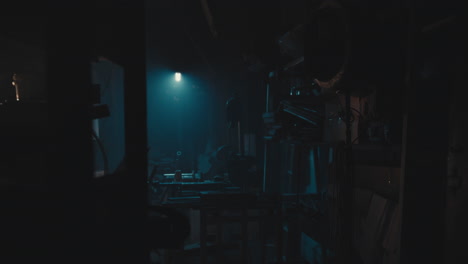 mysterious man in the workshop at night smokes a cigarette