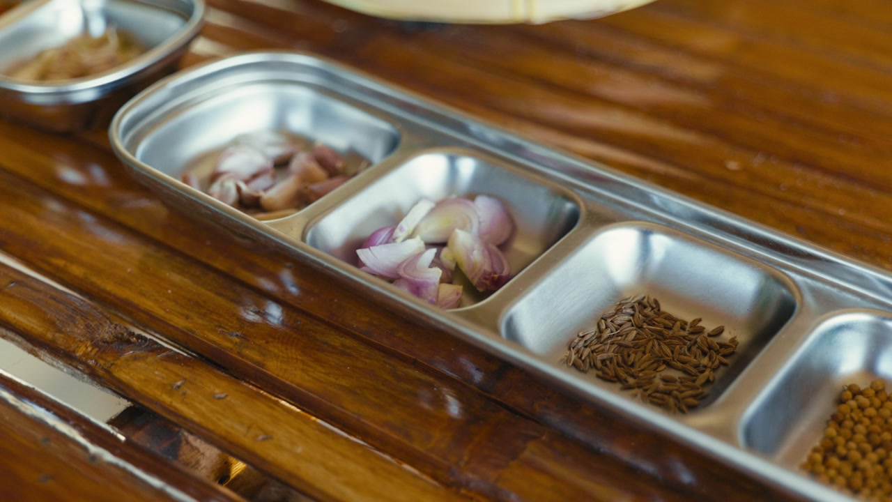 Seasoning ingredients prepared for making Thai chili paste, featuring fresh herbs and spices ready for traditional Thai cooking.