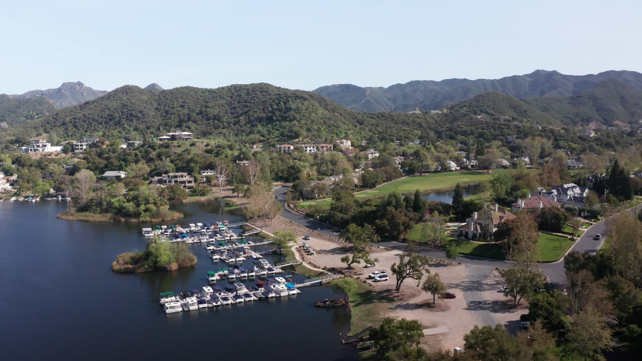 Wide panning aerial shot of a marina and golf course at the Sherwood Country Club in Southern California. 4K at 30 FPS