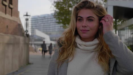 strong stylish young woman walks confidently down a city street