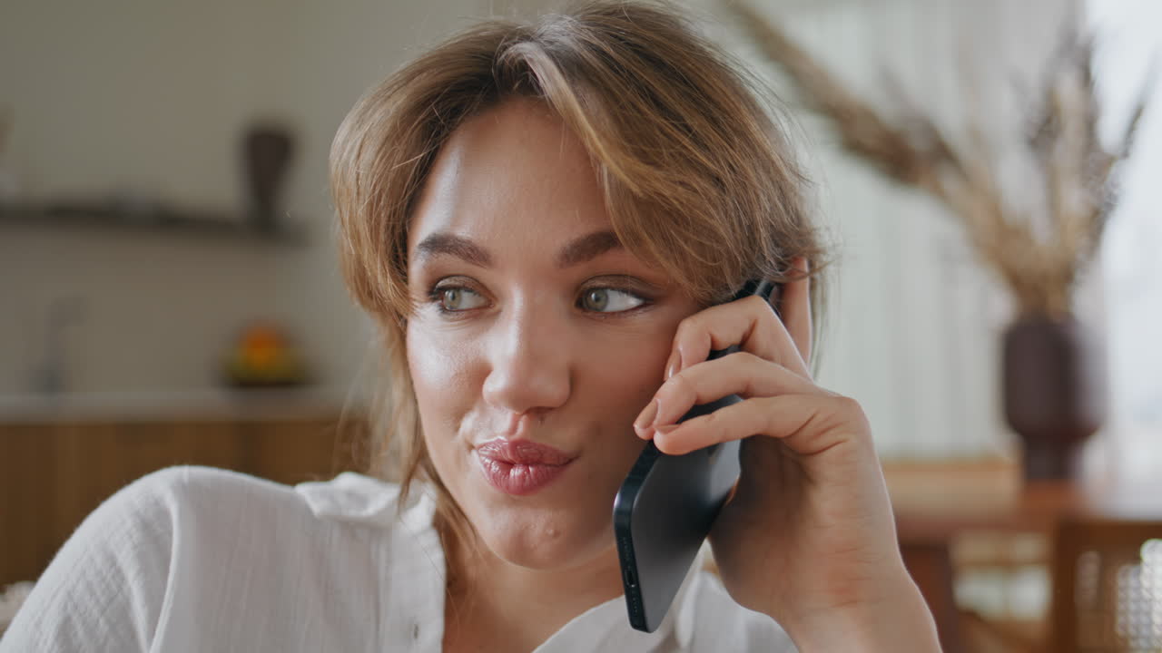 Cheerful girl making call relaxing home at weekend closeup. Relaxed lady smiling