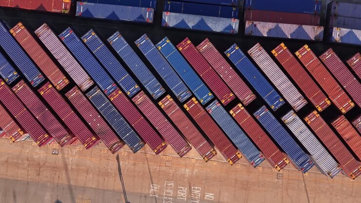 Aerial rising view looking down over rows of shipping containers at Tilbury 2 storage facility Essex