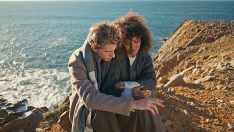 sensual couple romantic date at ocean cliff zoom on. lovers embracing at sea