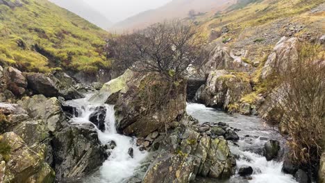 picturesque waterfall at helvellyn with clear water and windy weather - cumbria, uk