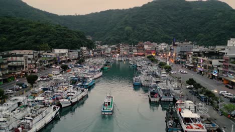 Nanfangao-Fishing-Port-Harbor-南方澳漁港-Taiwan-East-Coast-Yilan-County,-Fishing-Vessel-Boat-sails-into-Harbor-during-Sunset