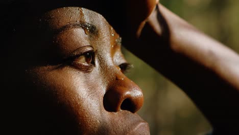 female jogger wiping sweat in the forest 4k