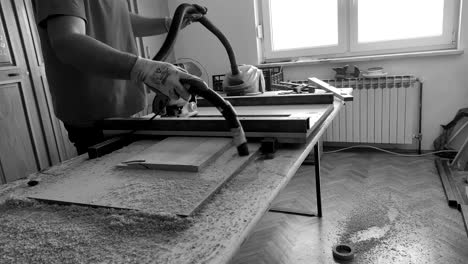 collecting the dust in small woodworking workshop at home