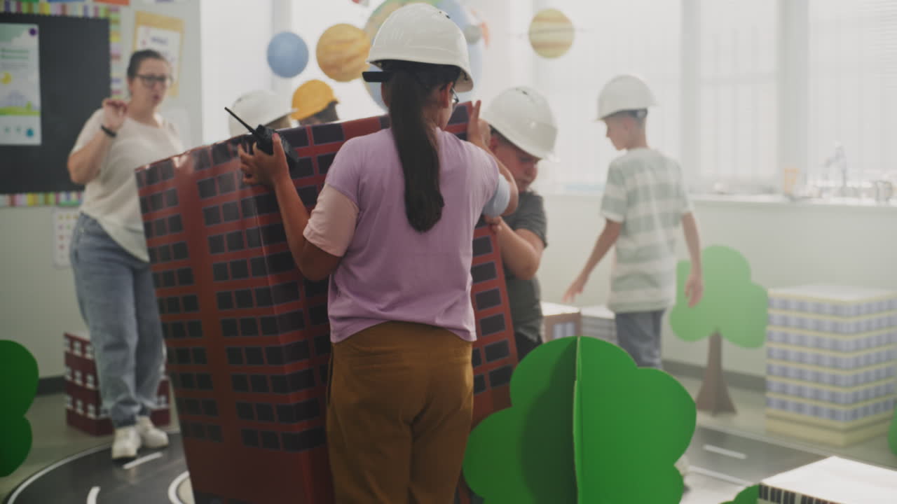 Team of Primary School Students in Hardhats Creating City Planning
