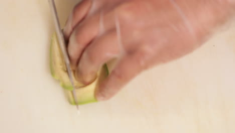 Slicing-Fresh-Avocado-Fruit-For-Sushi-Preparation---overhead-shot