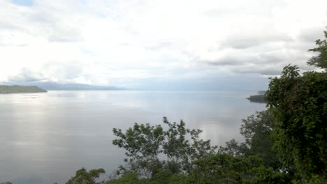 Drone-shot-flying-over-trees-to-reveal-a-tropical-beach-in-Costa-Rica