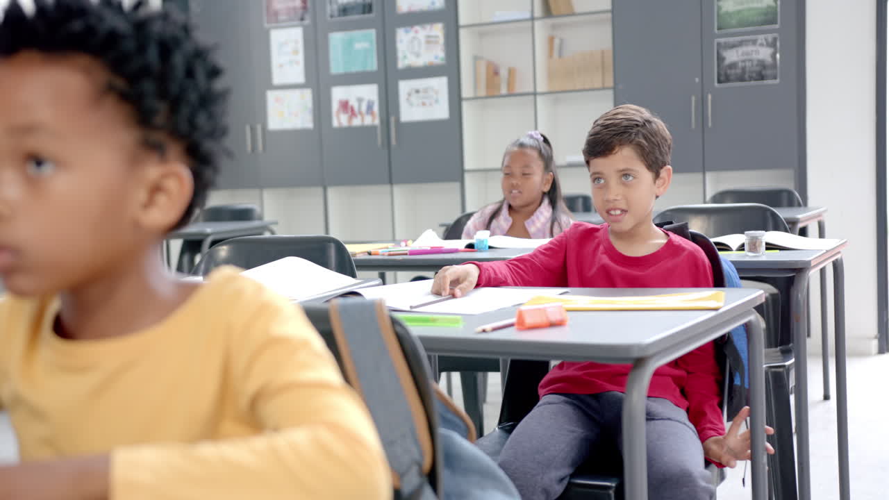 In school, children sitting at desks with colorful supplies in the classroom