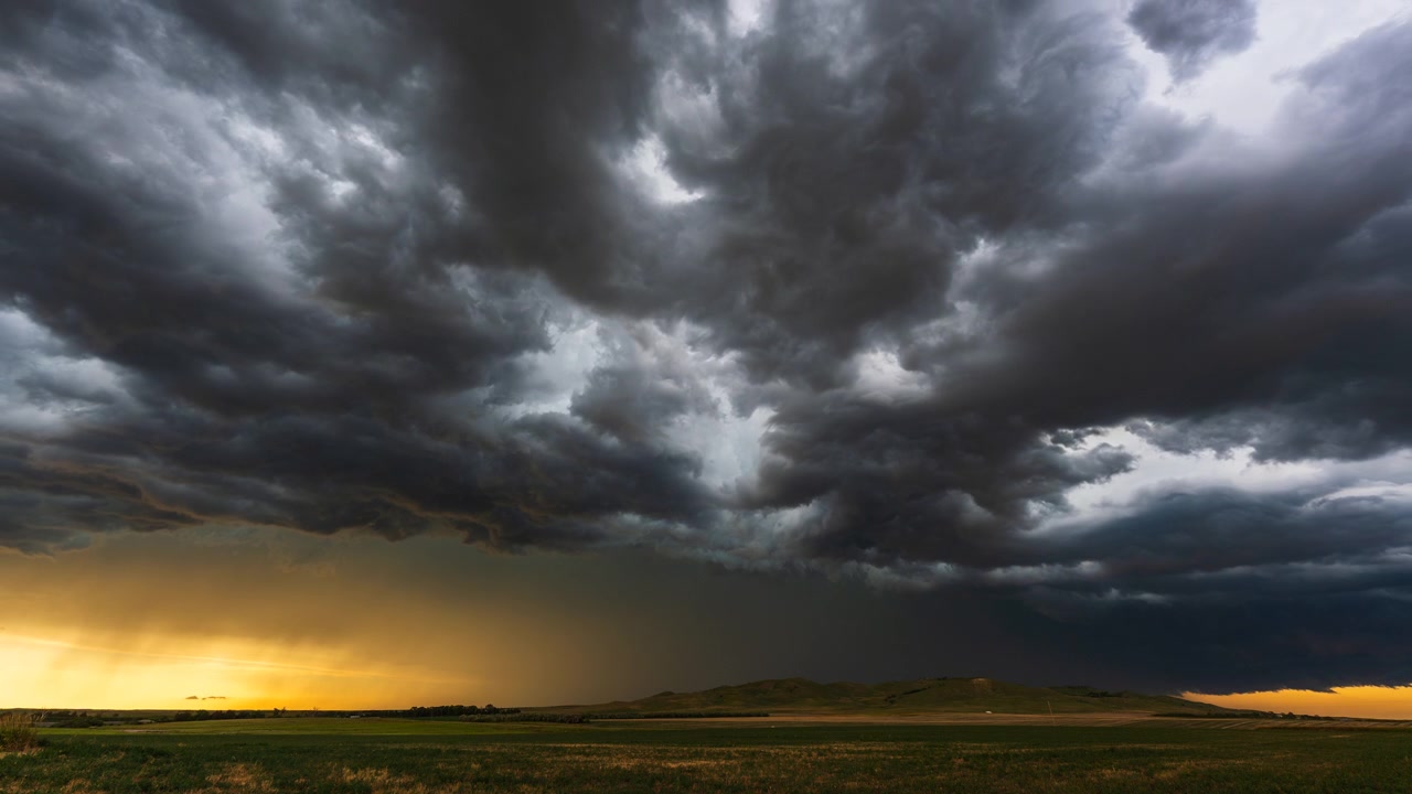 Thunderstorm clouds with lightning moving over countryside landscape