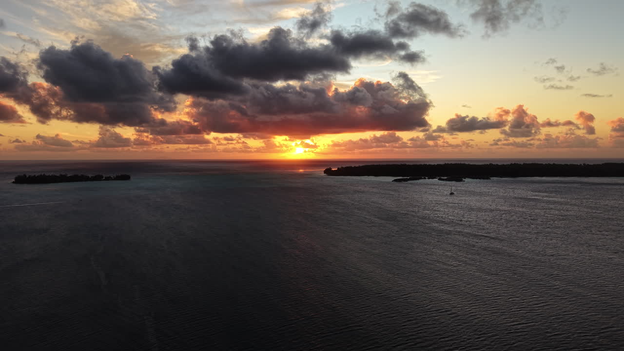 Sunset on Bora Bora Island, French Polynesia. Aerial View of Lagoon, Clouds and South Pacific Ocean