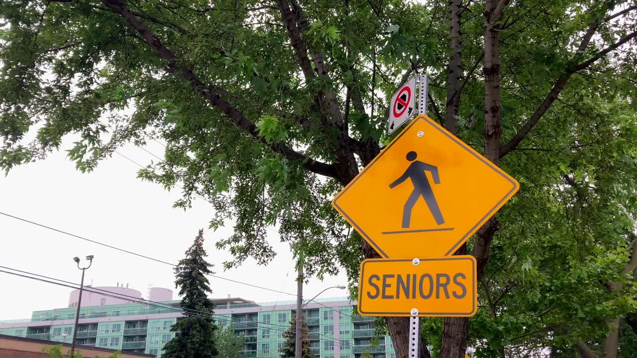 Senior citizens pedestrian safety road traffic warning sign in urban neighborhood
