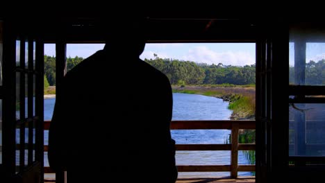 Man-walking-towards-balcony-at-home-4k