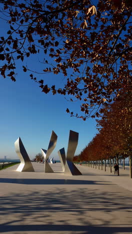 city park with modern sculptures and autumn foliage