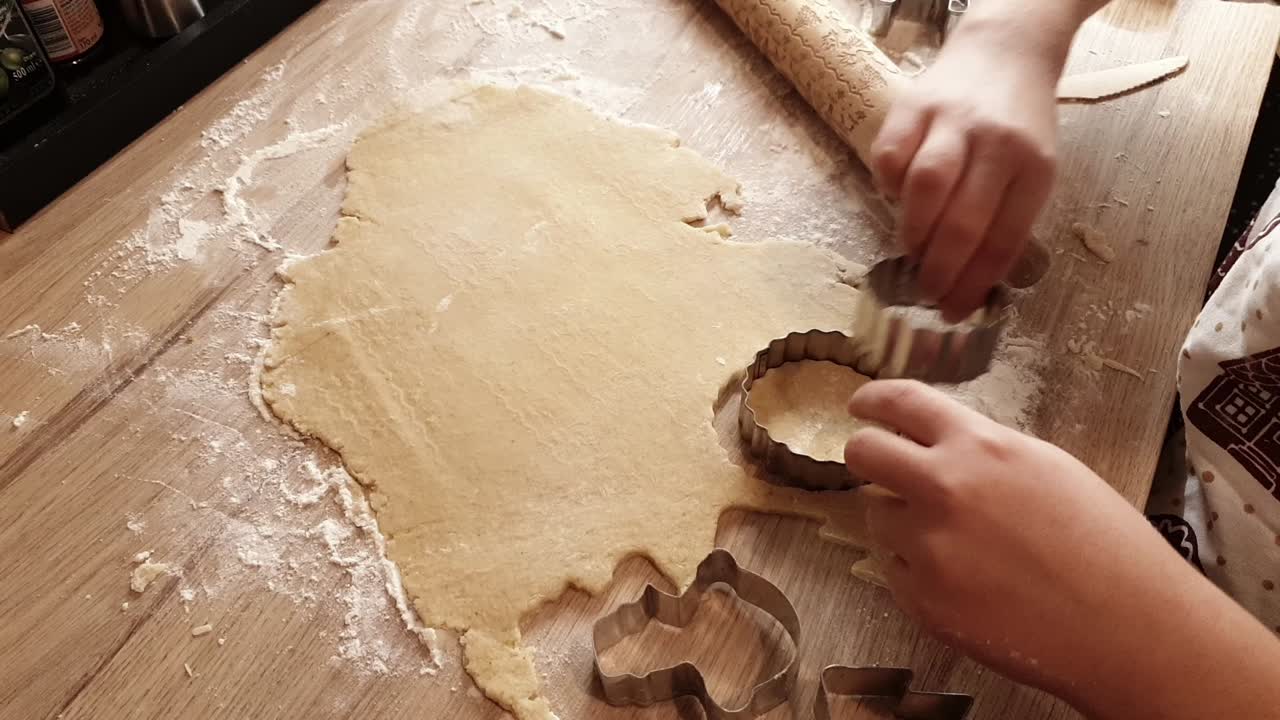 Dough being cut with templates to make sugar cookies