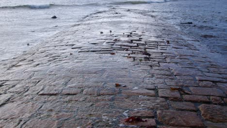 close up shot of the tide revealing the causeway at st michaels mount